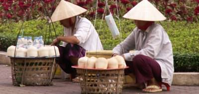 Holidays to Vietnam - coconut sellers on the streets of Hoi An